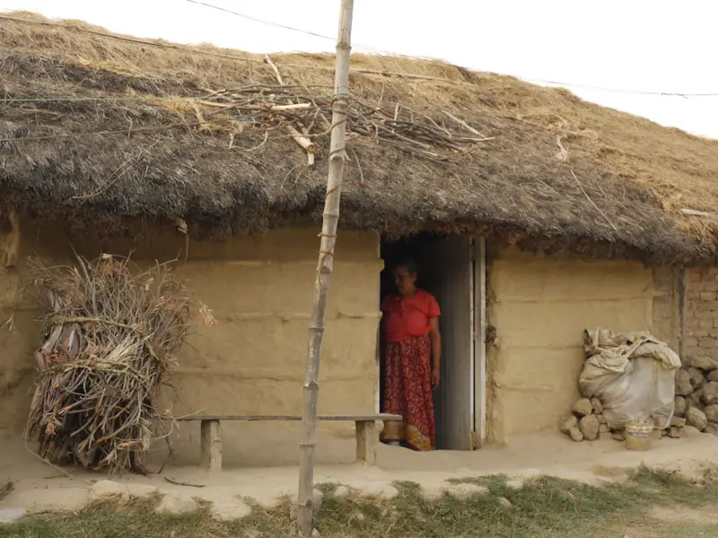 Traditional clay home with a thatched roof in Lumbini, Nepal