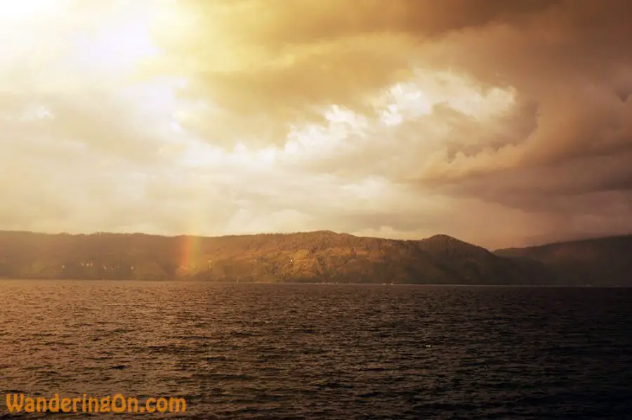 Looking across Danau Toba. Stunning clouds, rainbow and mountains on the far shore