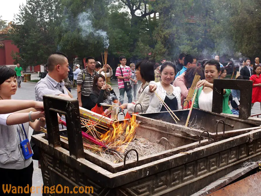 Locals lighting incense outside the Lama Temple, Beijing