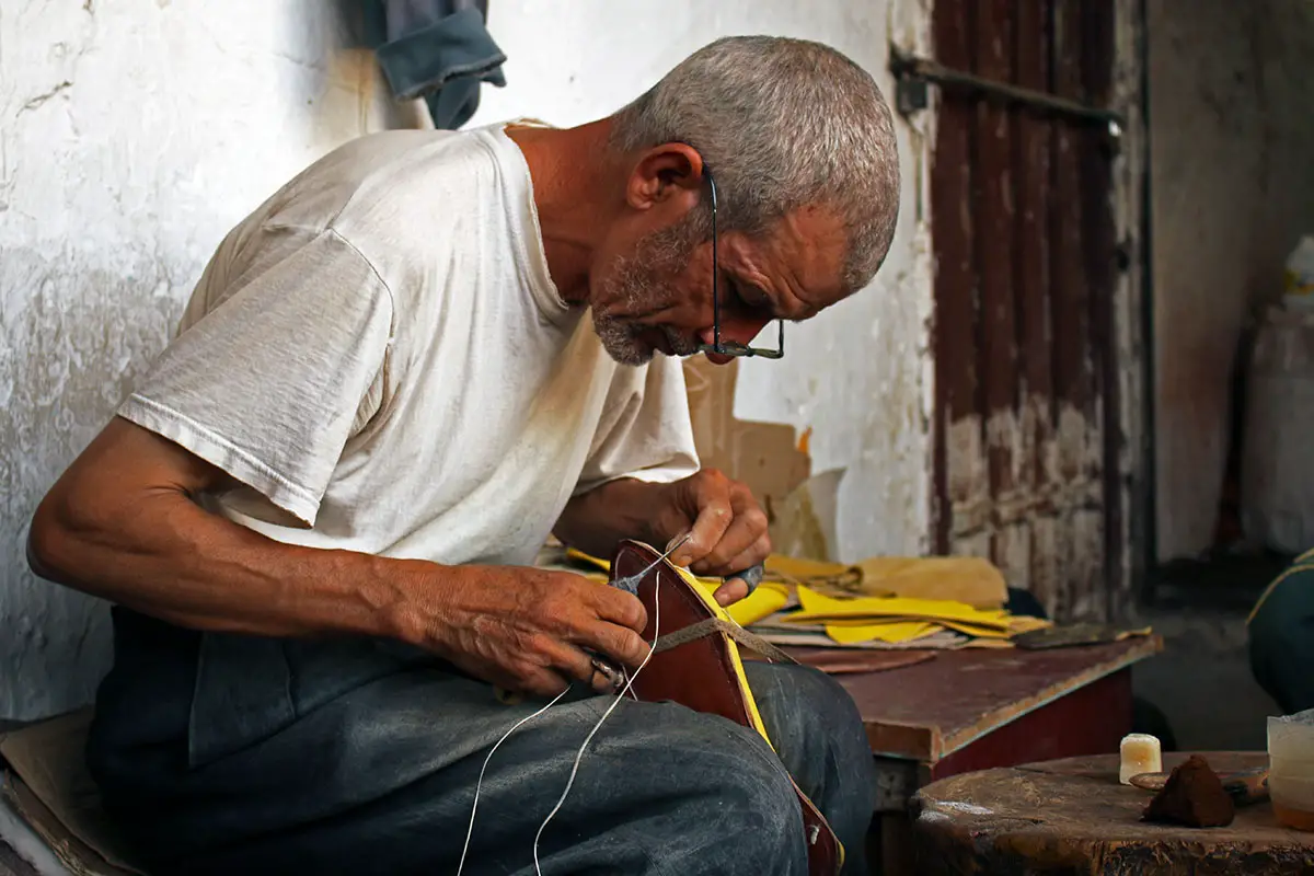 Stitching shoes by hand in the Fez Medina 