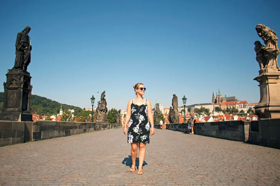 Walking across Charles bridge, one of the best free things to do in Prague, Prague on a budget