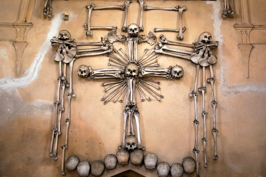 A macabre bone crucifix inside Sedlec Ossuary | A day trip from Prague to Kutna Hora bone church