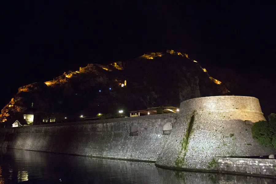 Kotor's old town walls with San Giovanni Fortress lit  up in the background  | things to see in Kotor